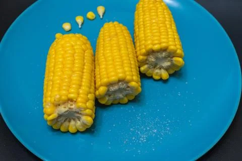 Corn in a plate on a dark background Stock Photos