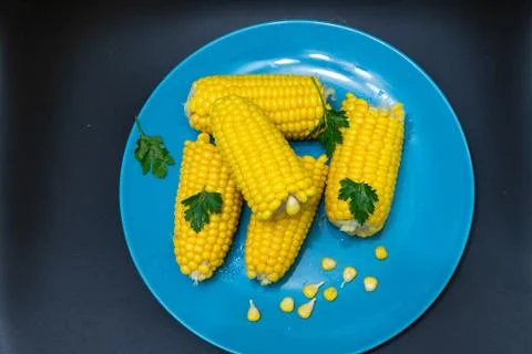 Corn in a plate on a dark background Stock Photos