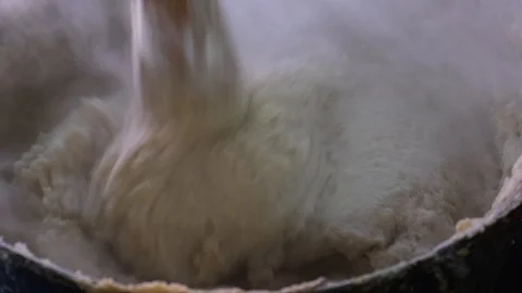 Corn porridge is cooked in a pan on fire. Hominy. Caucasian cuisine Vidéo 105163364
