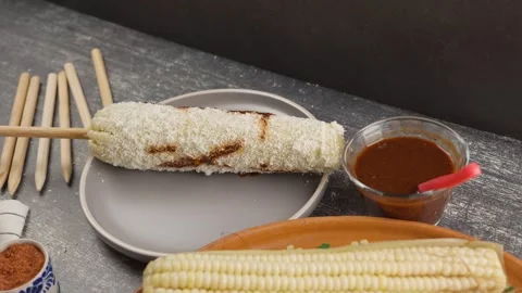 Corn prepared with the ingredients used Mayonnaise Aged cheese Red sauce Chilli Stock Footage 280316930