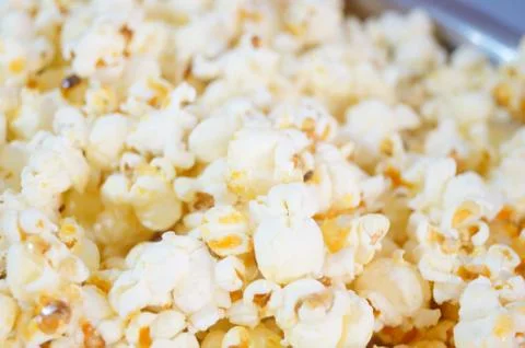 Corn is processed into popcorn snacks Stock Photos