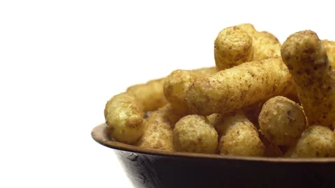 Corn puffs. Rotation. Close up. Puffcorn with peanut flavor.Isolated on white. Stock Footage 101297376