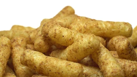 Corn puffs. Rotation. Close up. Puffcorn with peanut flavor.Isolated on white. Stock Footage 101298072
