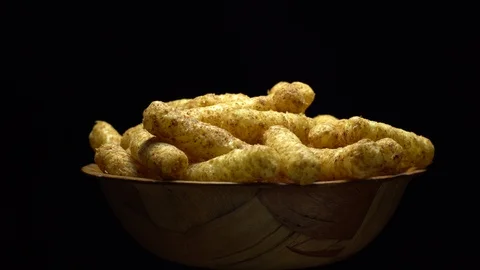 Corn puffs. Rotation. Close up.  Puffcorn with peanut flavor. Black background. Stock Footage 101299184