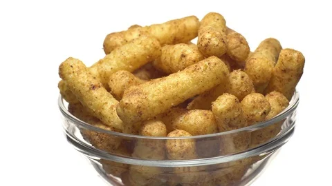 Corn puffs. Rotation. Close up. Puffcorn with peanut flavor.Isolated on white. Stock Footage 101303293