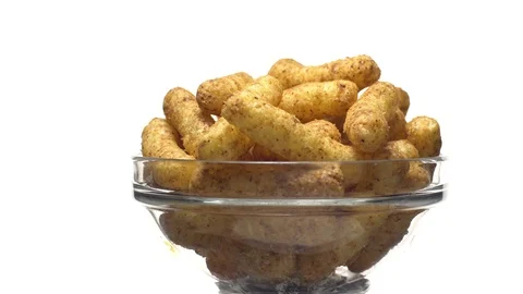 Corn puffs. Rotation. Close up. Puffcorn with peanut flavor.Isolated on white. Stock Footage 101303322