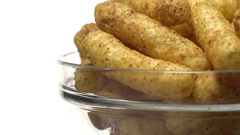 Corn puffs. Rotation. Close up. Puffcorn with peanut flavor.Isolated on white. 動画素材 101303486