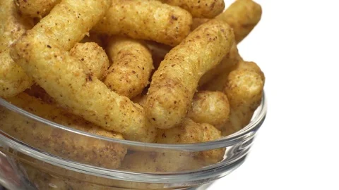 Corn puffs. Rotation. Close up. Puffcorn with peanut flavor.Isolated on white. Stock Footage 101303853