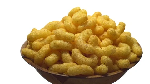 Corn puffs. Rotation. Close up. Puffcorn with peanut flavor.Isolated on white. Stock Footage 101313718