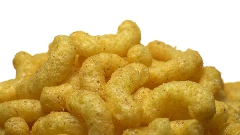 Corn puffs. Rotation. Close up. Puffcorn with peanut flavor.Isolated on white. Stock Footage 101313764