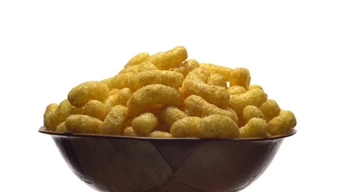 Corn puffs. Rotation. Close up. Puffcorn with peanut flavor.Isolated on white. Stock Footage 101313774