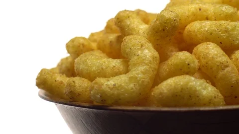 Corn puffs. Rotation. Close up. Puffcorn with peanut flavor.Isolated on white. Stock Footage 101313865