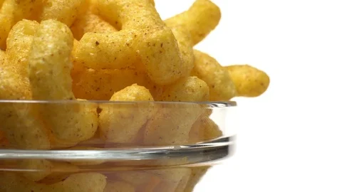 Corn puffs. Rotation. Close up. Puffcorn with peanut flavor.Isolated on white. Stock Footage 101313944