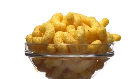 Corn puffs. Rotation. Close up. Puffcorn with peanut flavor.Isolated on white. Stock Footage 101313990