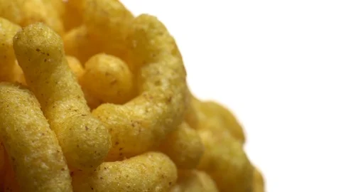 Corn puffs. Rotation. Close up. Puffcorn with peanut flavor.Isolated on white. Stock Footage 101313998