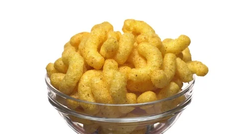 Corn puffs. Rotation. Close up. Puffcorn with peanut flavor.Isolated on white. Stock Footage 101314026