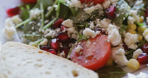 Corn salad with soft cheese, cherry tomato, pomegranate seed and sweetcorn kerne Stock Footage 121313244