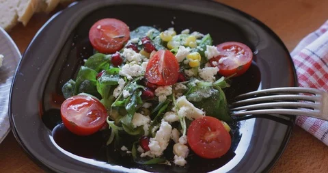 Corn salad with soft cheese, cherry tomato, pomegranate seed and sweetcorn kerne Stock Footage 121315222