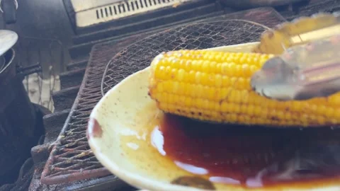 Corn in a Sauce Dish, Then Back over the Fire, Japanese Summer Festival Food Stock Footage 343078316