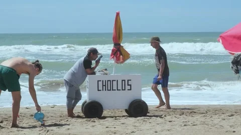 Corn seller on the Atlantic coast beach, Argentina Stock Footage 260779720