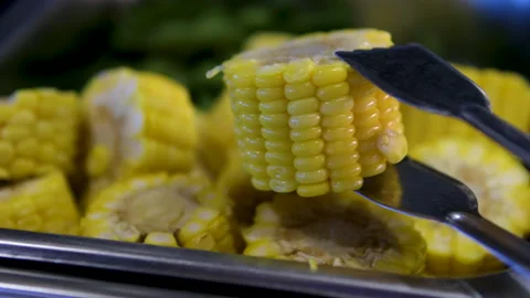 Corn slices tongs Barbeque brazier with a set of two cooked beef steaks and four Stock Footage 313757563