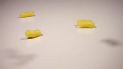Corn sticks fall on the table, spill out of the pack Stock Footage 131468422
