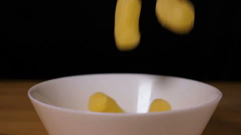Corn sticks falling into a plate Видео 126707880