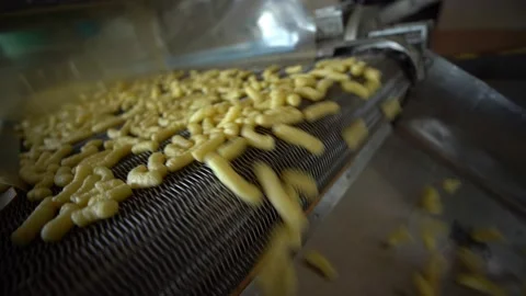 Corn sticks move along the conveyor. food industry. production of corn sticks Stock Footage 195816073