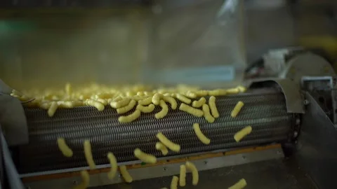 Corn sticks move along the conveyor. food industry. production of corn sticks Stock Footage 195816183