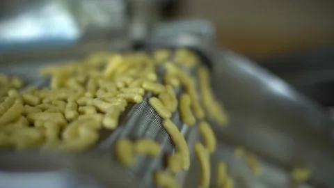 Corn sticks move on an automatic conveyor. Stock Footage 195816085