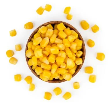 Corn in a tin can and scattered on a white. The view from the top. Stock Photos