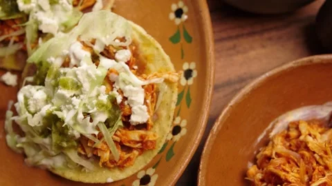 Corn toasts, chicken tinga, lettuce, sour cream, beans and green sauce Stock Footage 281392815