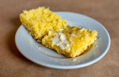Cornbread sliced with butter Stock Photos