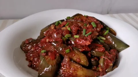 Corned Beef with Fried Eggplants in a White Plate Stock Footage 241512337