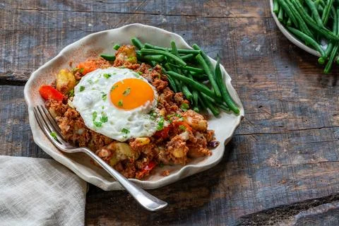 Corned beef hash with fried egg Stock Photos