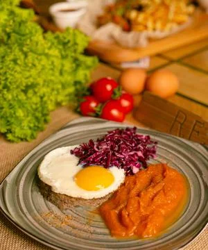 Corned beef hash meal with a crispy fried egg and pickled red cabbage Stock Photos