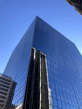 The Corner Angle Of A Large Mirrored Building In Montreal With Clear Blue Sky Stock Photos