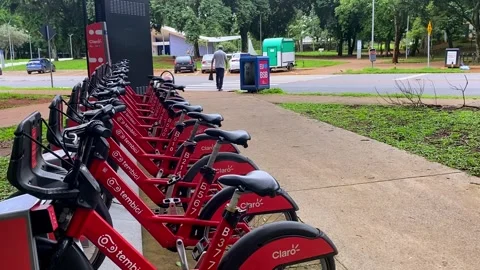 At the corner, a bike hire stand, rows of wheels at your command 動画素材 294359825