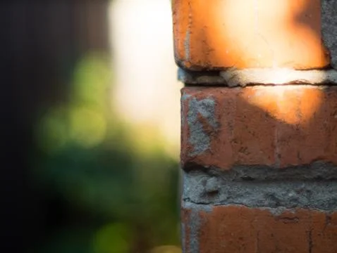 The corner of a brick wall close up Stock Photos