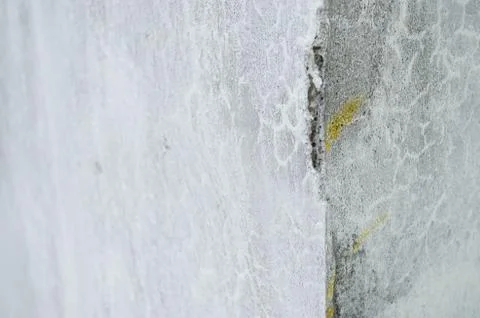 Corner of a broken gray cement wall, broken texture of the cement wall of the Stock Photos