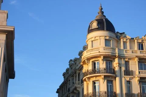 Corner building of Neoclassic architecture on clear blue sky background in Paris Stock Photos