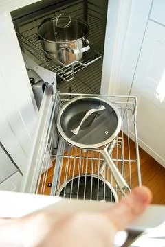 Corner cabinet with metal pull-out storage systems for pots and pans 库存照片