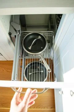 Corner cabinet with metal pull-out storage systems for pots and pans 库存照片
