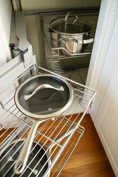 Corner cabinet with metal pull-out storage systems for pots and pans 库存照片