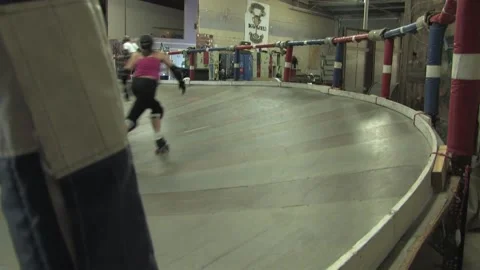 Corner camera angle as skaters train on track, Texas Roller Derby Stock Footage 232957318
