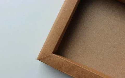 Corner Of Carton Packaging Case With Sides On White Table Stock Photos