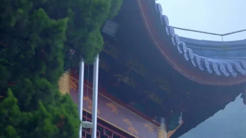 A corner of the eaves of an ancient building in the rain and fog Stock Footage 235134587