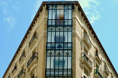 Corner of elegant classical building with windows and balconies decorated w.. Stock Photos