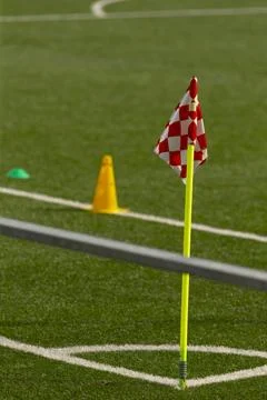 Corner flag and training cones on green soccer pitch Stock Photos