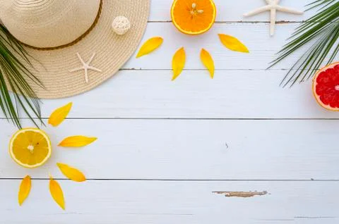 Corner frame arranged by a summer hat, tropical palm leaves, fresh citrus fruits Stock Photos